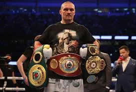 Oleksandr Usyk holding WBA, WBC, IBF and WBO heavyweight belts after becoming undisputed champion